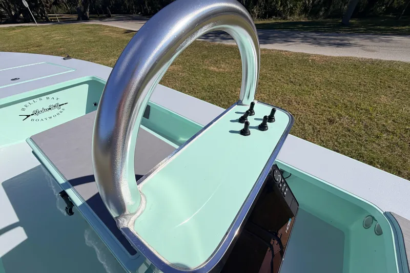 Slide: The Image of 2011 Hell's Bay Glades Skiff boat console with metallic steering wheel and controls. - 34