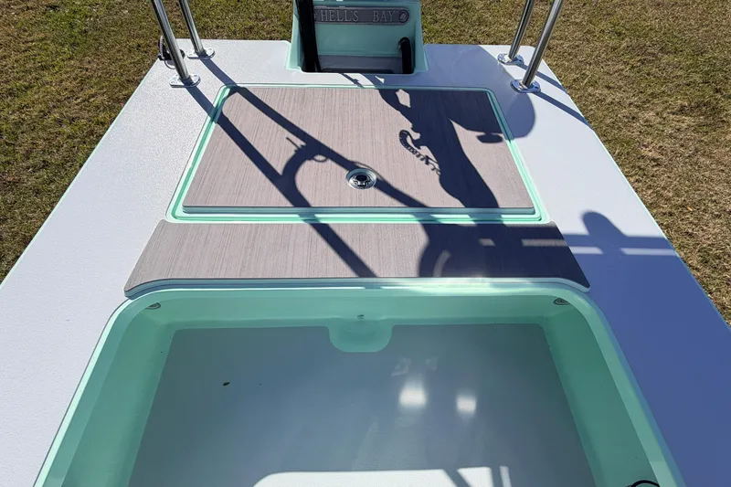 Slide: The Image of 2011 Hell's Bay Glades Skiff boat deck with storage compartments and clean design. - 38