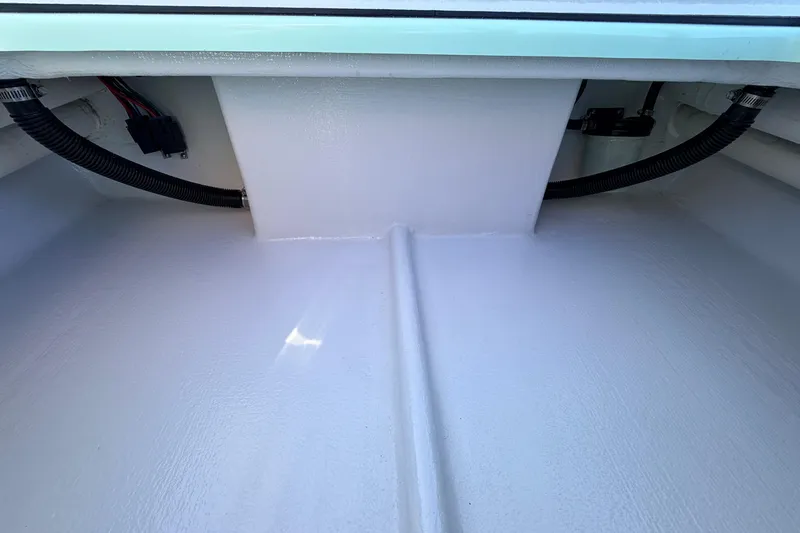 Slide: The Image of 2011 Hell's Bay Glades Skiff interior with visible wiring and tubing. - 41