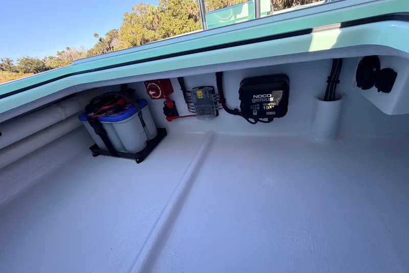 Slide: The Image of 2011 Hell's Bay Glades Skiff interior with battery and NOCO Genius charger. - 42