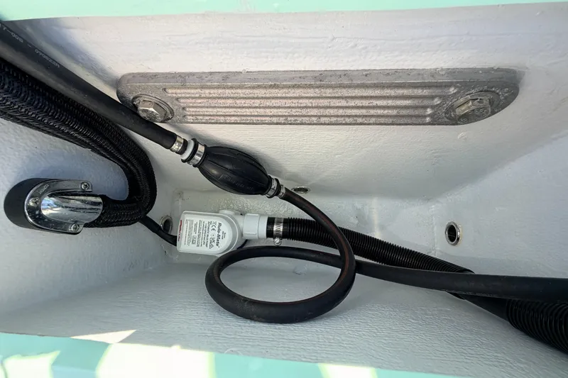 Slide: The Image of Interior view of 2011 Hell's Bay Glades Skiff showing hoses and fittings. - 44