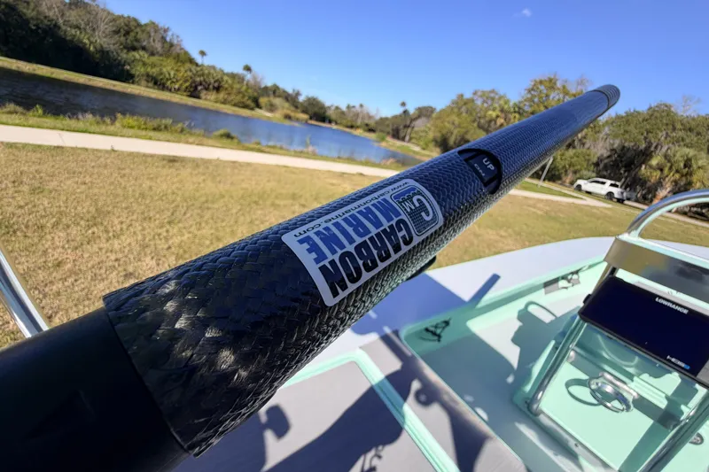 Slide: The Image of 2011 Hell's Bay Glades Skiff with carbon marine pole by a scenic riverbank. - 45