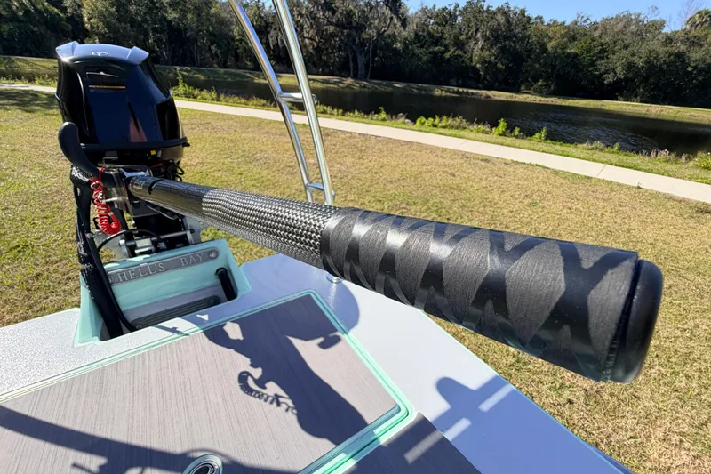 Slide: The Image of 2011 Hell's Bay Glades Skiff with carbon fiber push pole near a scenic waterway. - 46
