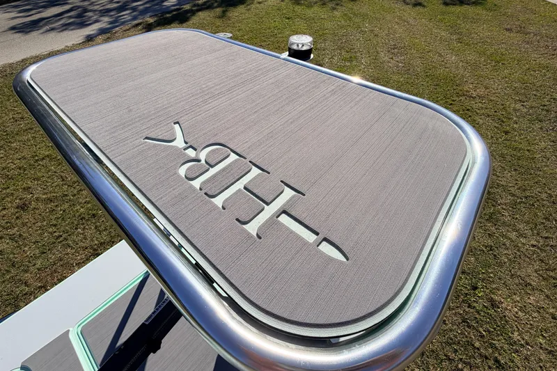 Slide: The Image of 2011 Hell's Bay Glades Skiff platform with logo, featuring sleek design and metallic frame. - 47