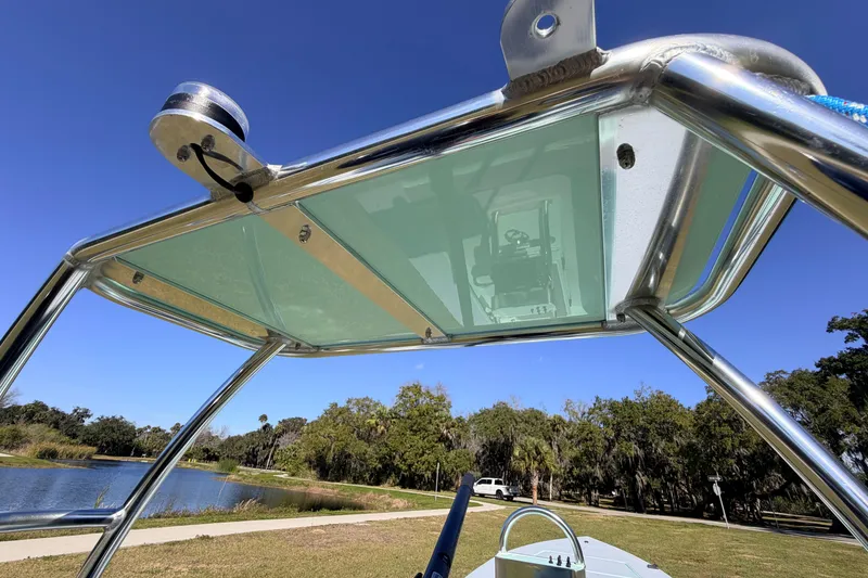 Slide: The Image of 2011 Hell's Bay Glades Skiff boat with a sleek metal frame and clear canopy. - 48