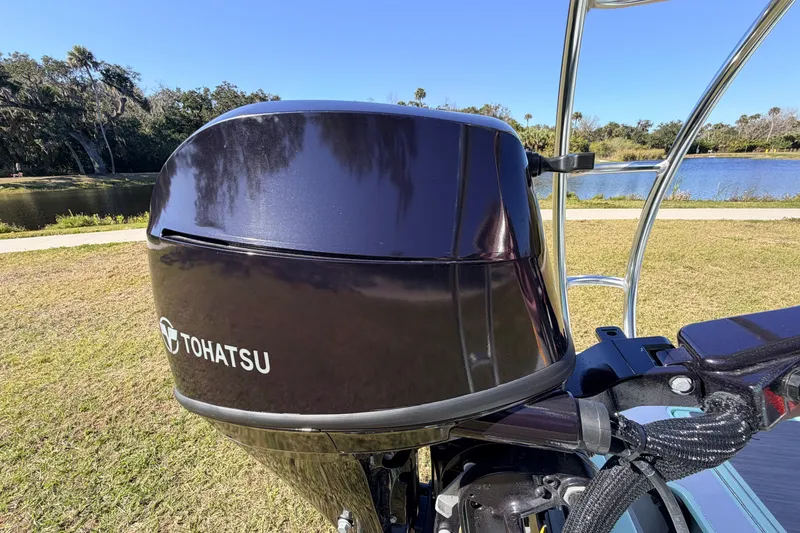 Slide: The Image of 2011 Hell's Bay Glades Skiff with Tohatsu outboard motor by a scenic lake. - 50