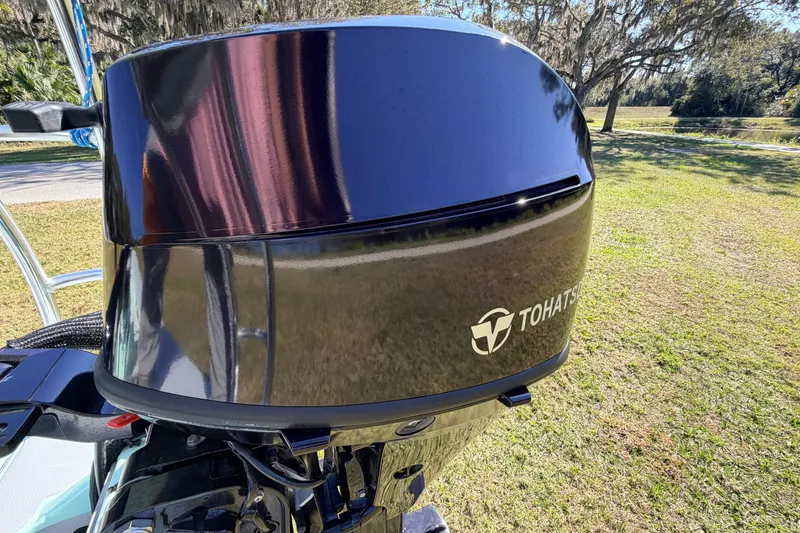 Slide: The Image of 2011 Hell's Bay Glades Skiff with Tohatsu outboard motor in a grassy area. - 51