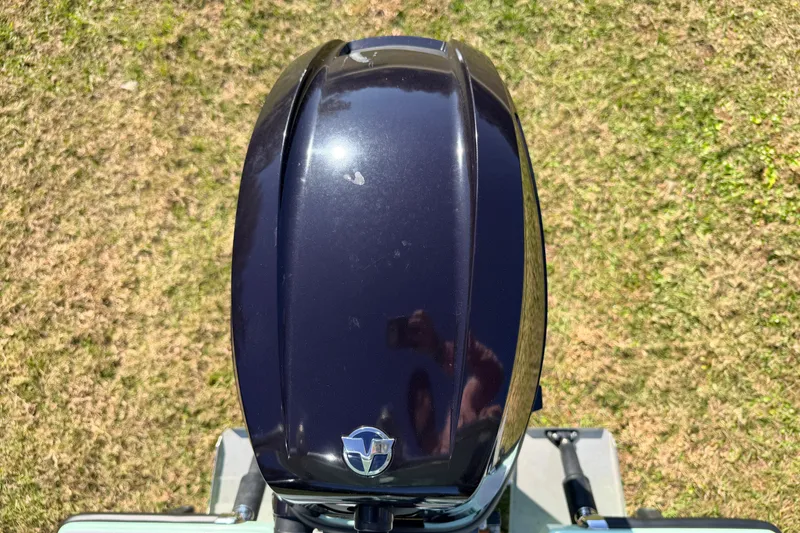 Slide: The Image of Top view of a 2011 Hell's Bay Glades Skiff outboard motor on grass. - 52