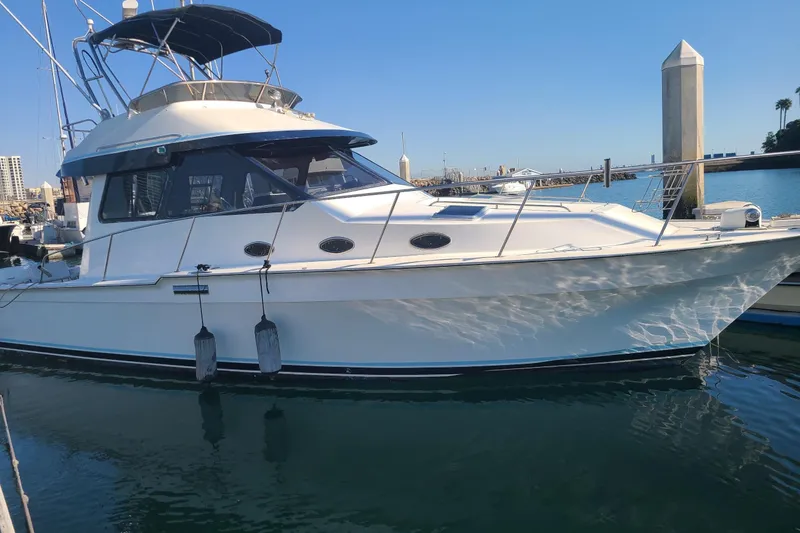The Image of 1987 Mediterranean 38 yacht docked in marina, featuring sleek design and spacious cabin. - 1