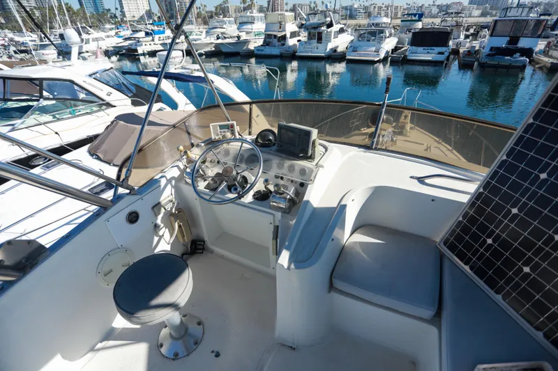 Slide: The Image of Cockpit view of a 1987 Mediterranean 38 yacht docked in a marina. - 11