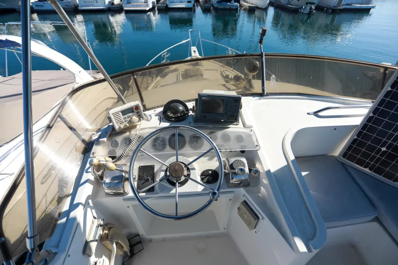Slide: The Image of Cockpit of a 1987 Mediterranean 38 yacht with steering wheel and navigation equipment. - 12