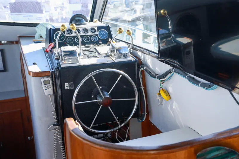 Slide: The Image of Cockpit of a 1987 Mediterranean 38 boat with steering wheel and control panel. - 13