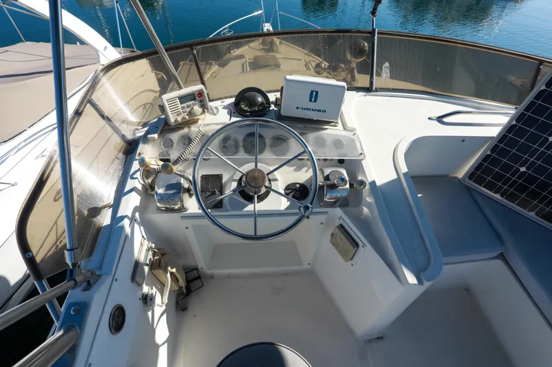 Slide: The Image of Cockpit of a 1987 Mediterranean 38 boat with steering wheel and navigation equipment. - 15