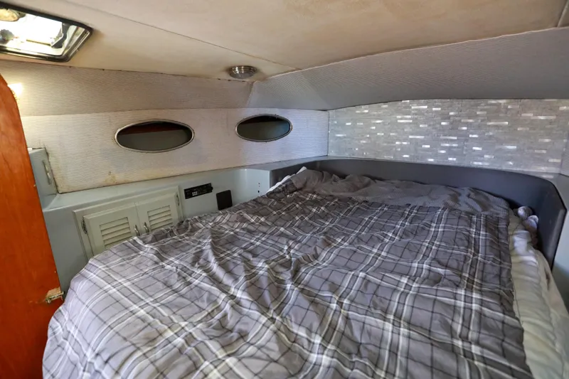 Slide: The Image of Cozy cabin interior of a 1987 Mediterranean 38 boat with plaid bedding. - 23