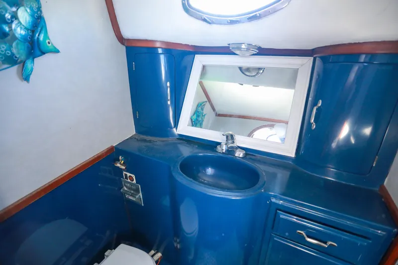 Slide: The Image of Blue bathroom interior of 1987 Mediterranean 38 yacht with sink, mirror, and fish decor. - 25