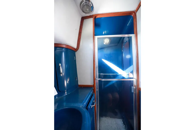 Slide: The Image of Interior of 1987 Mediterranean 38 yacht bathroom with blue fixtures and wooden trim. - 26