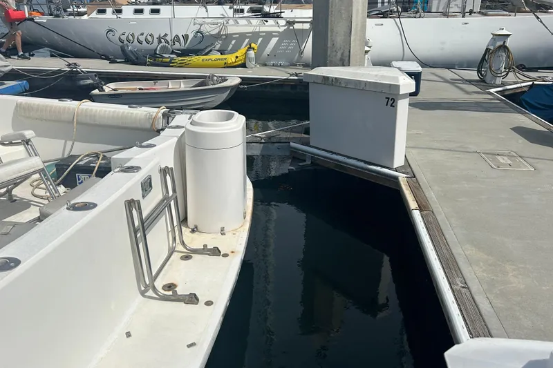 Slide: The Image of Docked Mediterranean 38 yacht from 1987 at marina with nearby boats and dock number 72. - 28