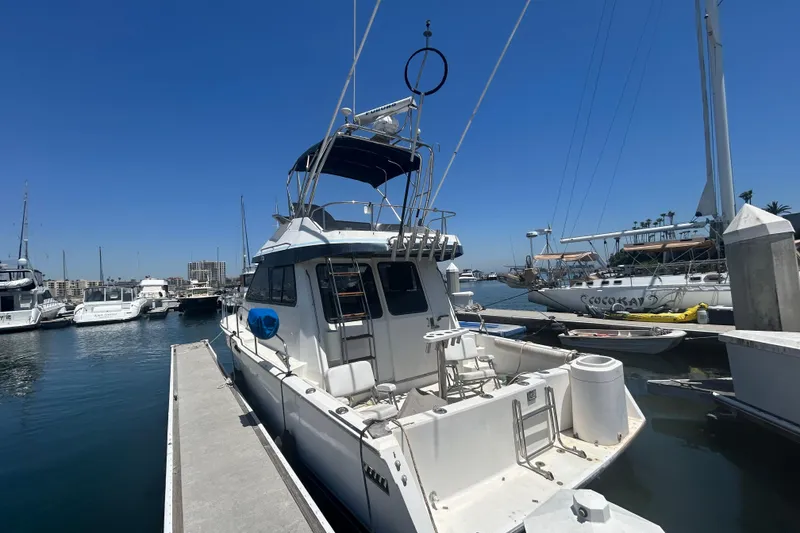 Slide: The Image of 1987 Mediterranean 38 yacht docked at marina under clear blue sky. - 3