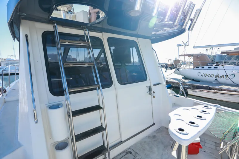 Slide: The Image of 1987 Mediterranean 38 yacht with ladder and fishing rod holders in a marina. - 5