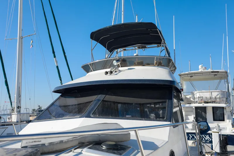 Slide: The Image of 1987 Mediterranean 38 yacht docked at marina under clear blue sky. - 7