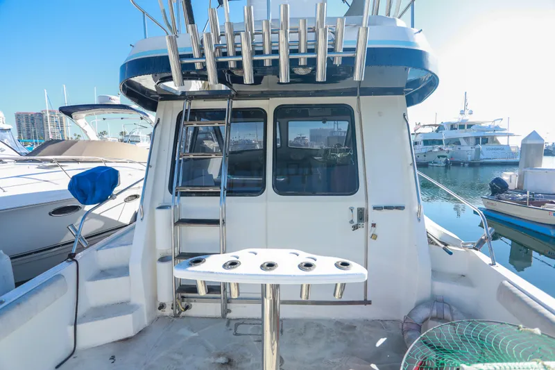 Slide: The Image of 1987 Mediterranean 38 yacht with fishing rod holders, docked in a marina. - 8