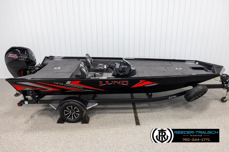 The Image of 2025 Lund 1975 Renegade fishing boat with Mercury Pro XS engine, displayed indoors. - 1