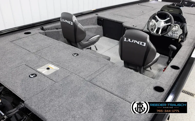 Slide: The Image of 2025 Lund 1975 Renegade boat interior with gray carpet and dual seats. - 10