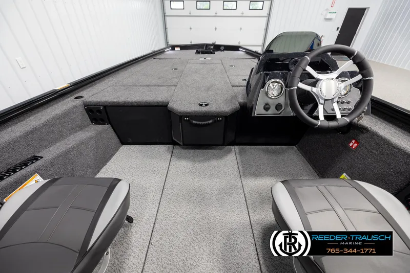 Slide: The Image of Interior of 2025 Lund 1975 Renegade boat with steering wheel and seating. - 12