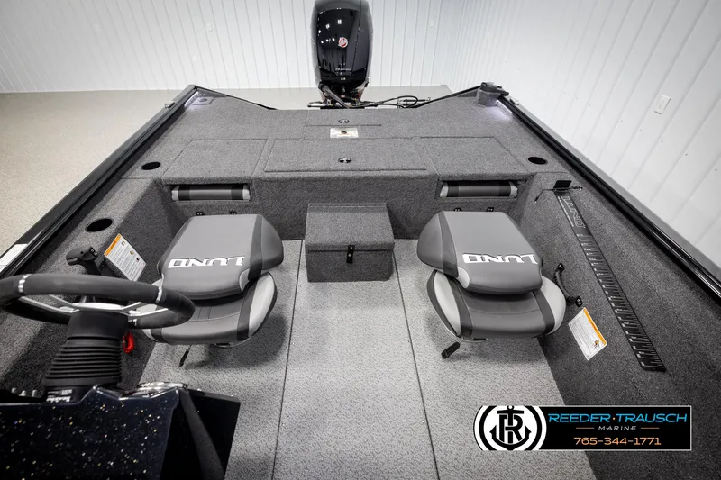 Slide: The Image of 2025 Lund 1975 Renegade boat interior with dual seats and steering wheel. - 24