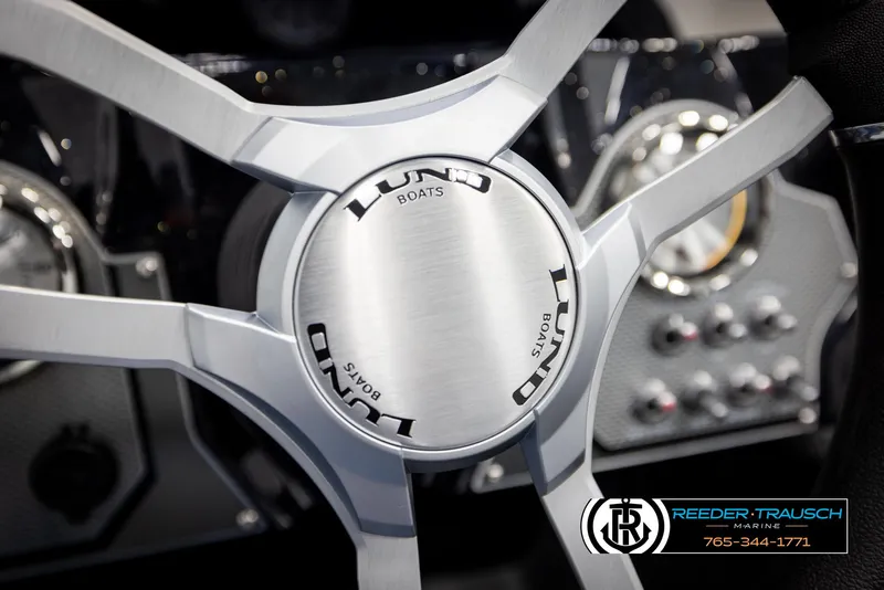 Slide: The Image of Steering wheel of 2025 Lund 1975 Renegade boat, featuring sleek design and modern controls. - 27