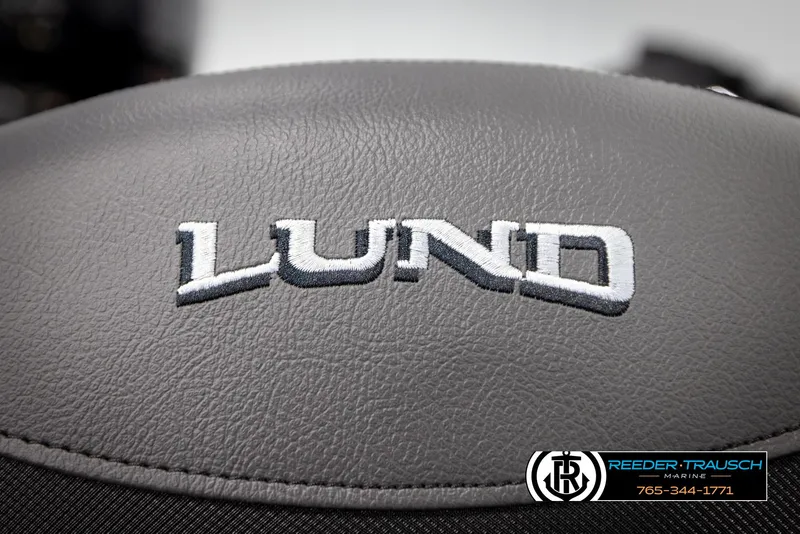 Slide: The Image of Lund 1975 Renegade 2025 logo on gray leather surface, Reeder-Trausch Marine branding. - 39