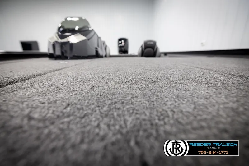 Slide: The Image of Lund 1975 Renegade 2025 model, interior view with carpeted flooring, Reeder-Trausch Marine logo. - 42