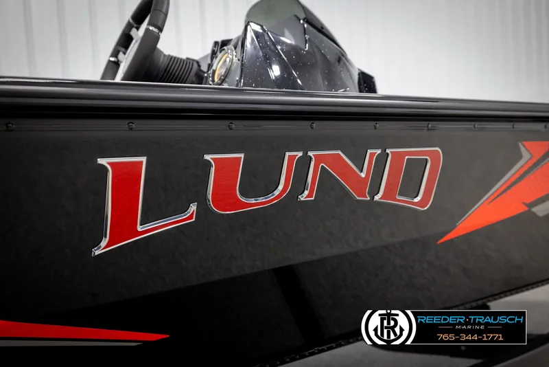 Slide: The Image of Lund 1975 Renegade 2025 boat with red logo, showcased at Reeder-Trausch Marine. - 47