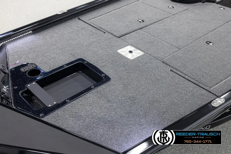 Slide: The Image of 2025 Lund 1975 Renegade boat deck with carpeted surface and storage compartments. - 8