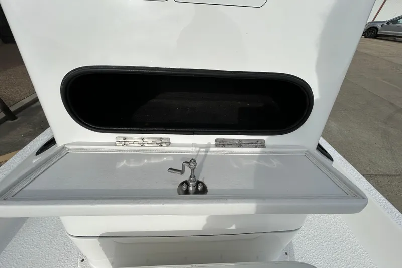 Slide: The Image of 2018 SCB Recon boat with open storage compartment and faucet on deck. - 18