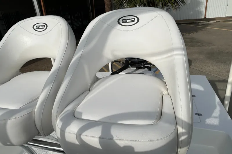Slide: The Image of 2018 SCB Recon boat seats, white leather, outdoor setting. - 19