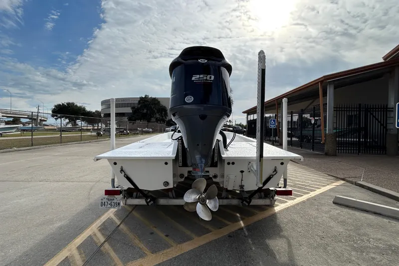 Slide: The Image of 2018 SCB Recon boat with powerful outboard motor on trailer in parking lot. - 2
