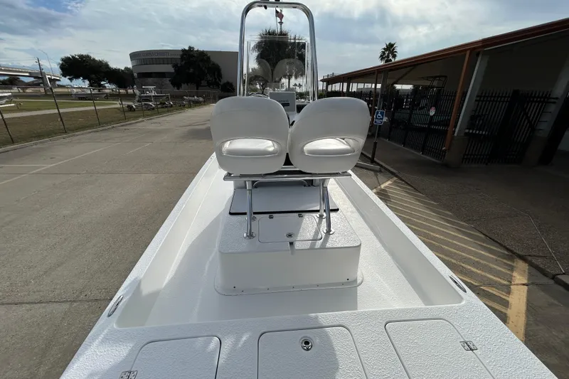 Slide: The Image of 2018 SCB Recon boat with dual seats, parked outdoors on a sunny day. - 21