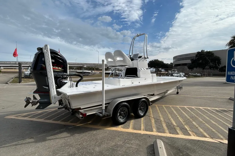 Slide: The Image of 2018 SCB Recon boat on trailer in parking lot under cloudy sky. - 3