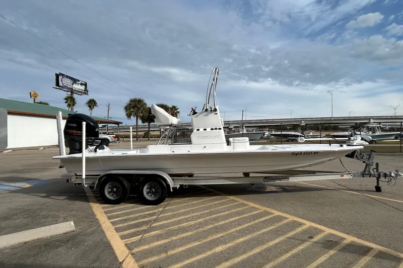 Slide: The Image of 2018 SCB Recon boat on trailer in parking lot under cloudy sky. - 4