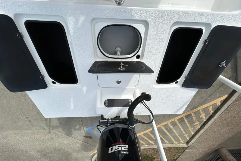 Slide: The Image of 2018 SCB Recon boat with Yamaha 250 engine, featuring storage compartments and a sink. - 9