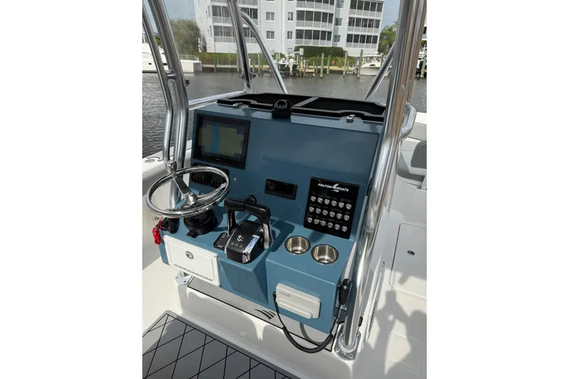 Slide: The Image of Control panel of 2026 Falcon Boats 26, featuring steering wheel and navigation system. - 15