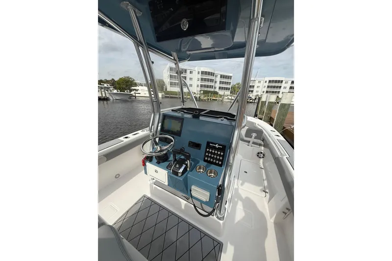 Slide: The Image of 2026 Falcon Boats 26 cockpit with modern controls and waterfront view. - 16