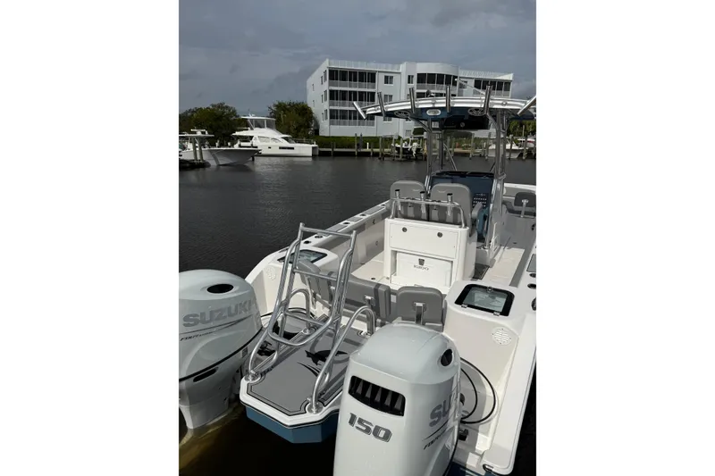 Slide: The Image of 2026 Falcon Boats 26 with Suzuki engines docked near waterfront buildings. - 19