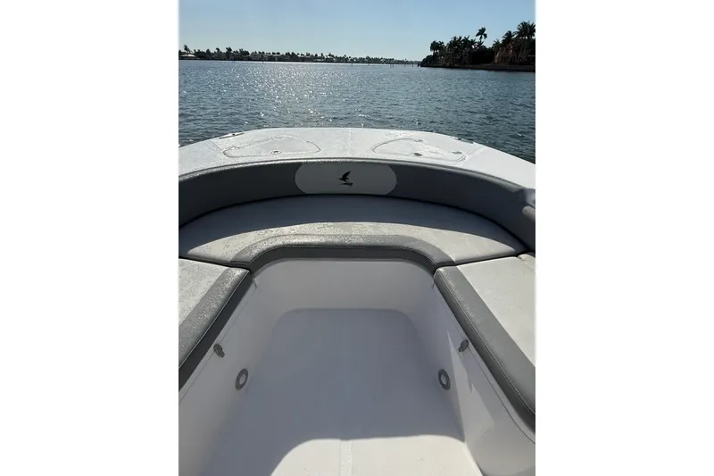 Slide: The Image of 2026 Falcon Boats 26 model, featuring spacious seating, on a serene water backdrop. - 7