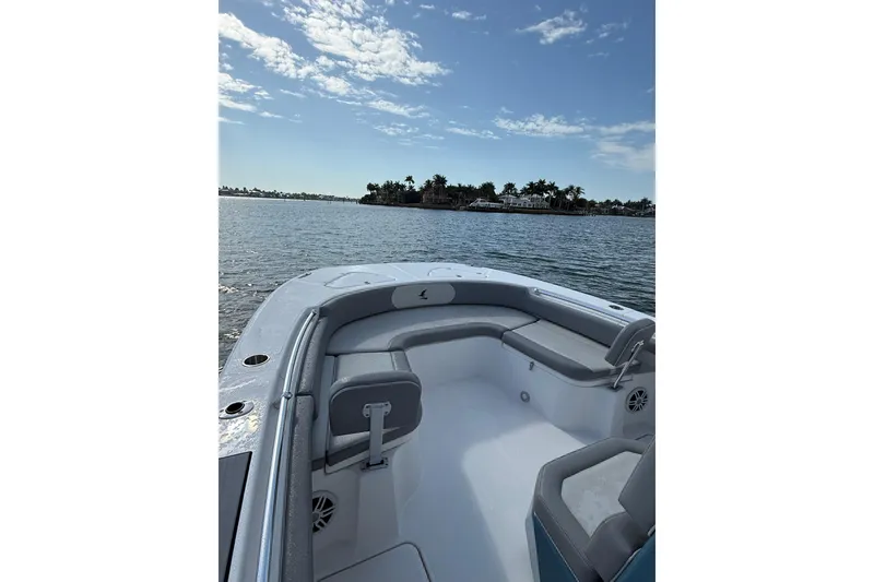 Slide: The Image of 2026 Falcon Boats 26 on calm water, featuring spacious seating and scenic view. - 9