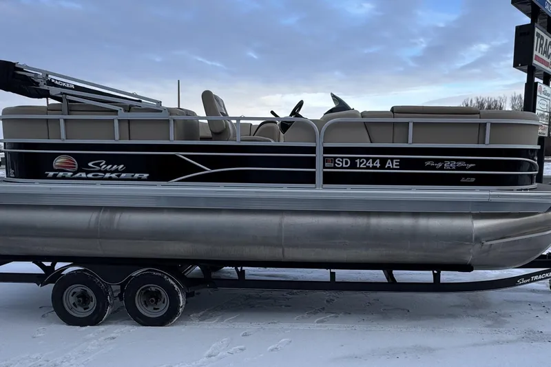 Slide: The Image of 2018 Sun Tracker Party Barge 22 XP3 pontoon boat on trailer in snowy setting. - 10