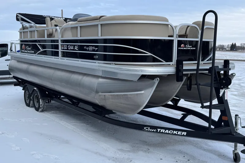 Slide: The Image of 2018 Sun Tracker Party Barge 22 XP3 pontoon boat on trailer in snowy setting. - 4