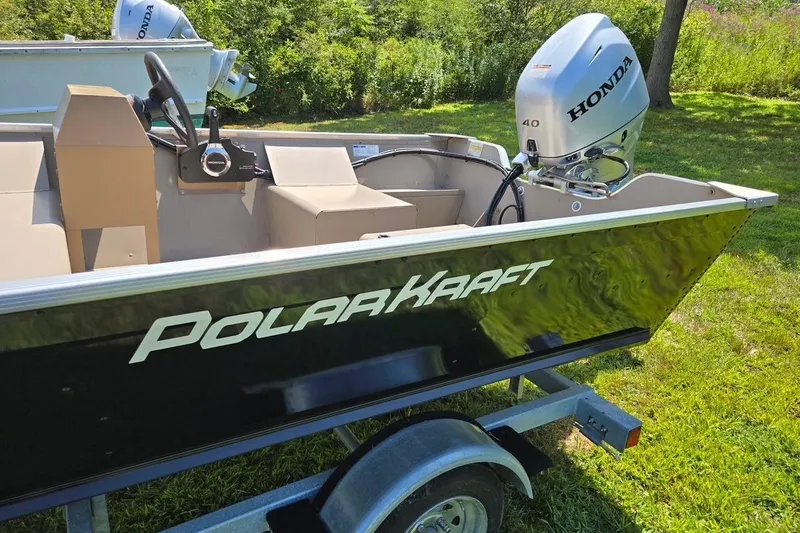 Slide: The Image of 2024 Polar Kraft Dakota boat with Honda outboard motor on a trailer. - 3