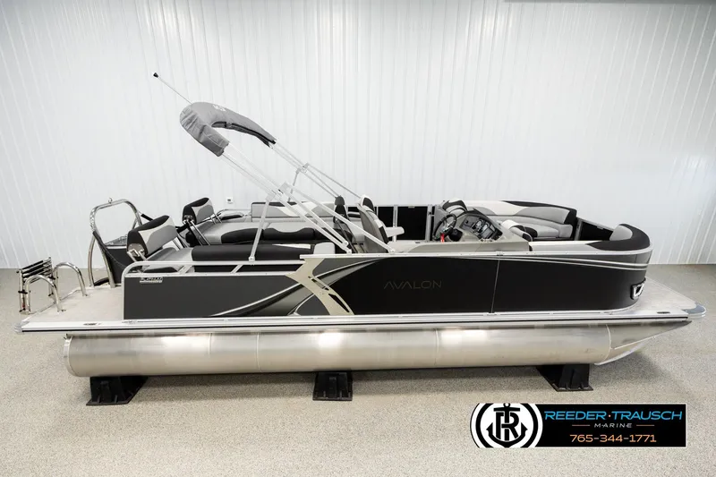 The Image of 2026 Avalon LSZ QLS pontoon boat in showroom, featuring sleek design and modern amenities. - 1